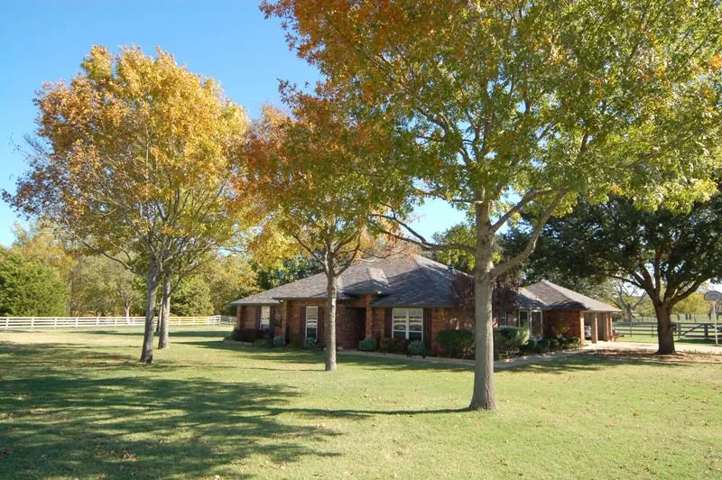 Brick home on a wooded Fairview lot in autumn